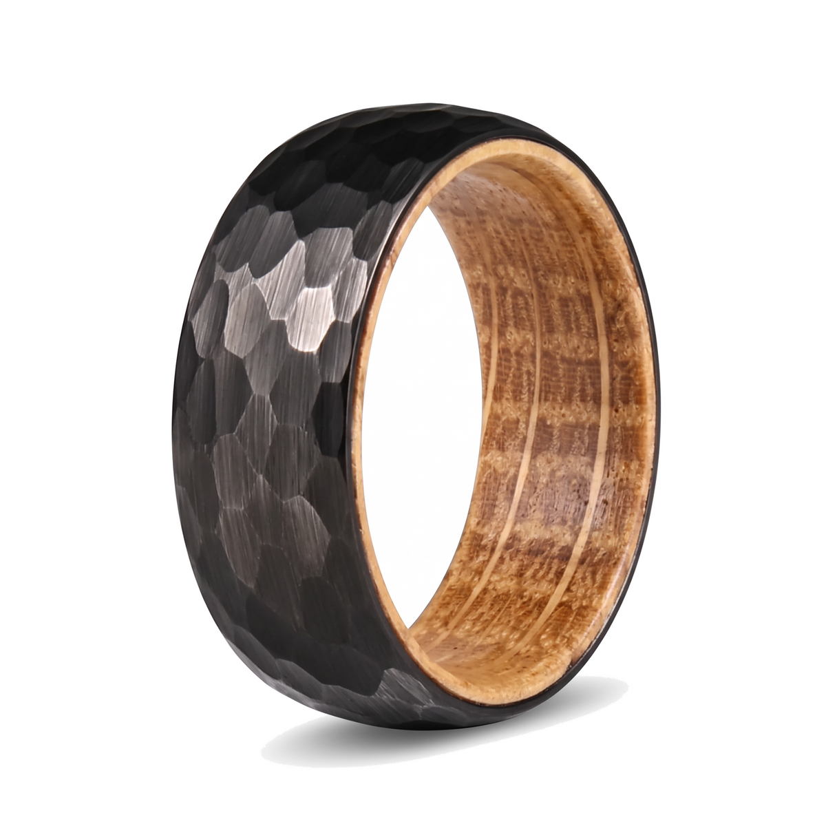 The Cask black hammered tungsten ring with a whiskey barrel wood interior on a white background