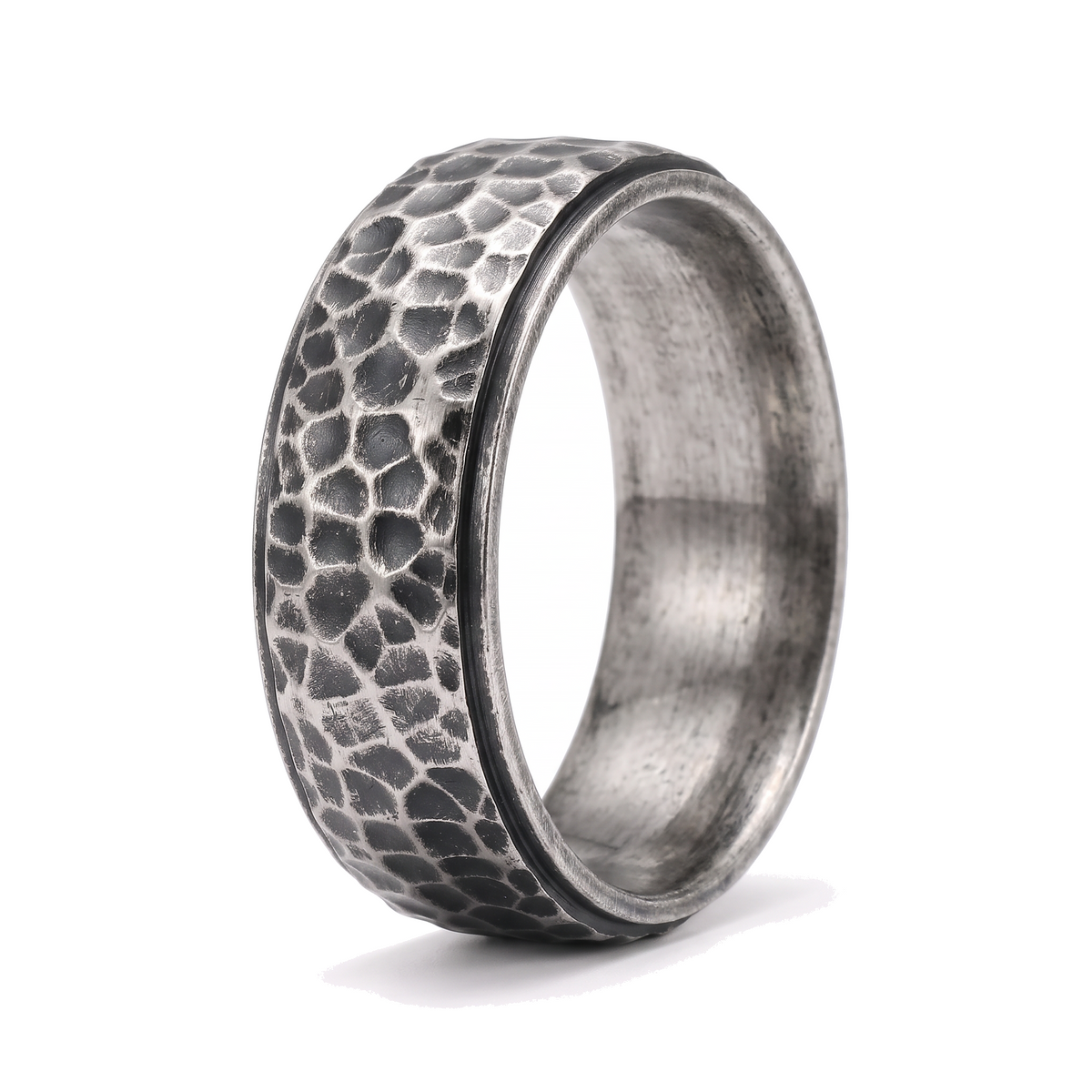 The Crater antique stainless steel ring with a beat forged hammered surface on a white background