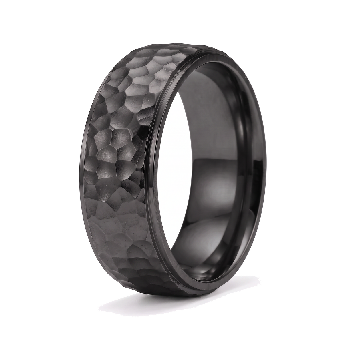 The Crater black stainless steel ring with a beat forged hammered surface on a white background