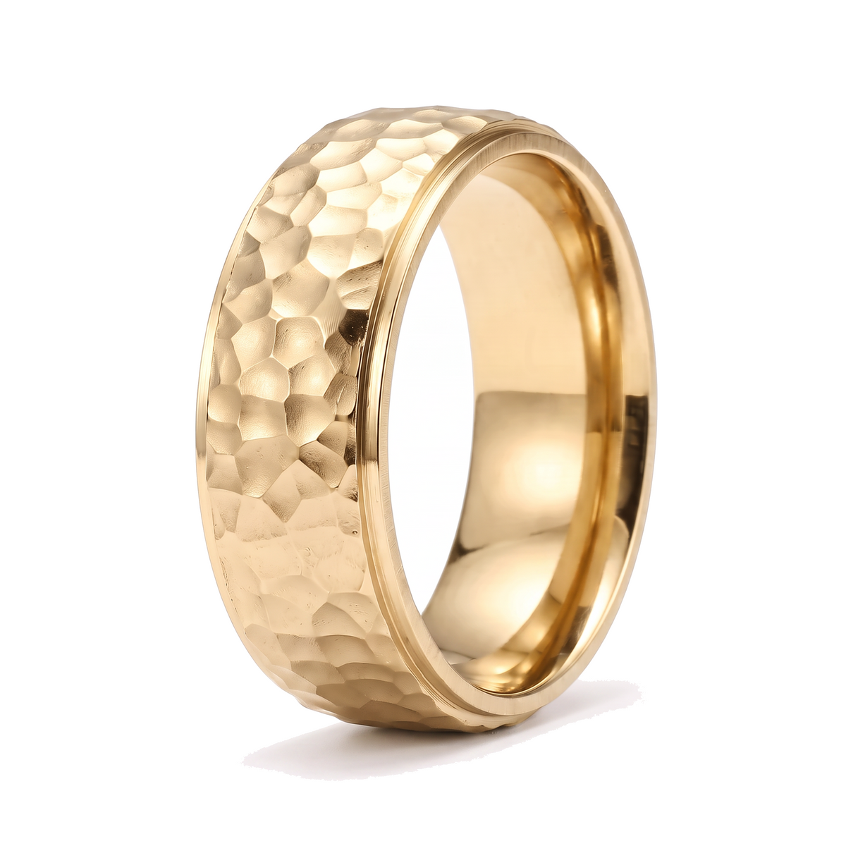 The Crater gold stainless steel ring with a beat forged hammered surface on a white background