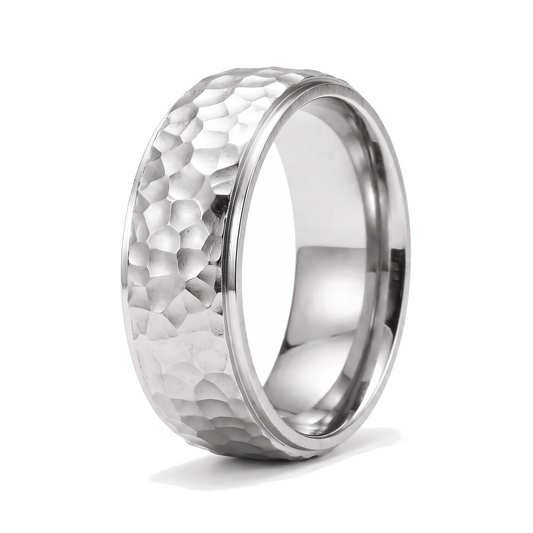 The Crater silver stainless steel ring with a beat forged hammered surface on a white background
