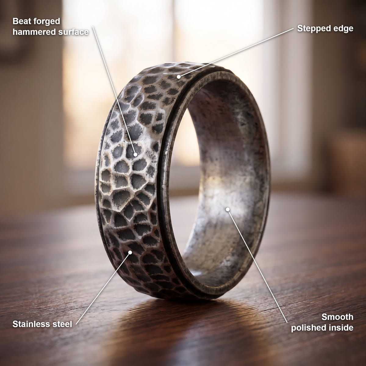 The Crater ring details in antique finish: beat forged hammered surface, stepped edge, stainless steel, smooth polished inside