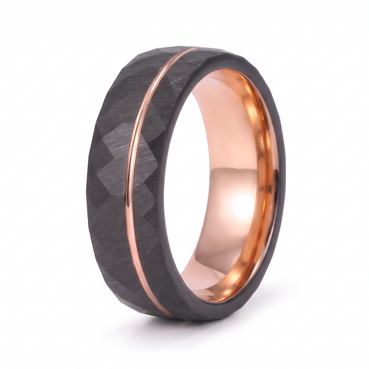 The Daybreak black hammered tungsten ring with rose gold groove and interior on a white background