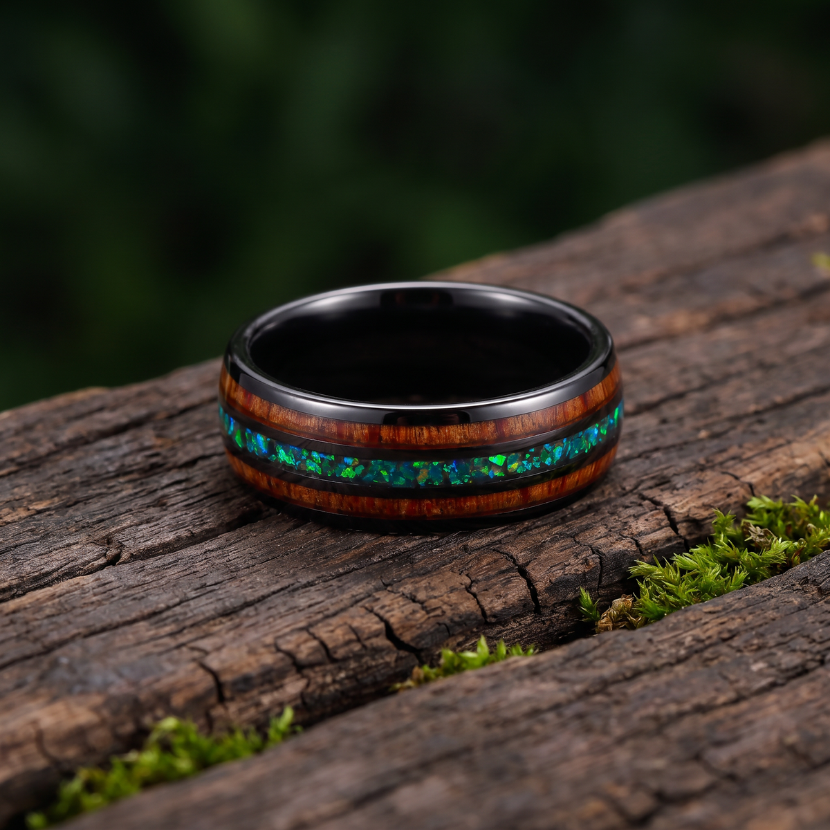 The Canopy ring lying flat on weathered dark wood with green moss