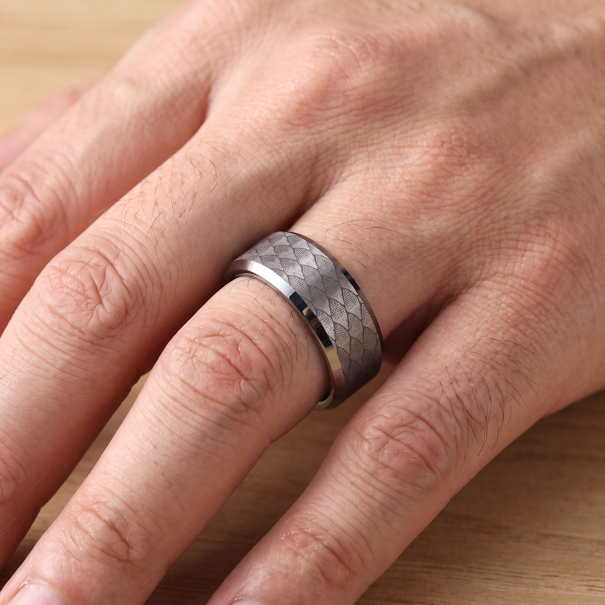 Close up of a man's hand wearing The Serpentine tungsten ring with a silver interior