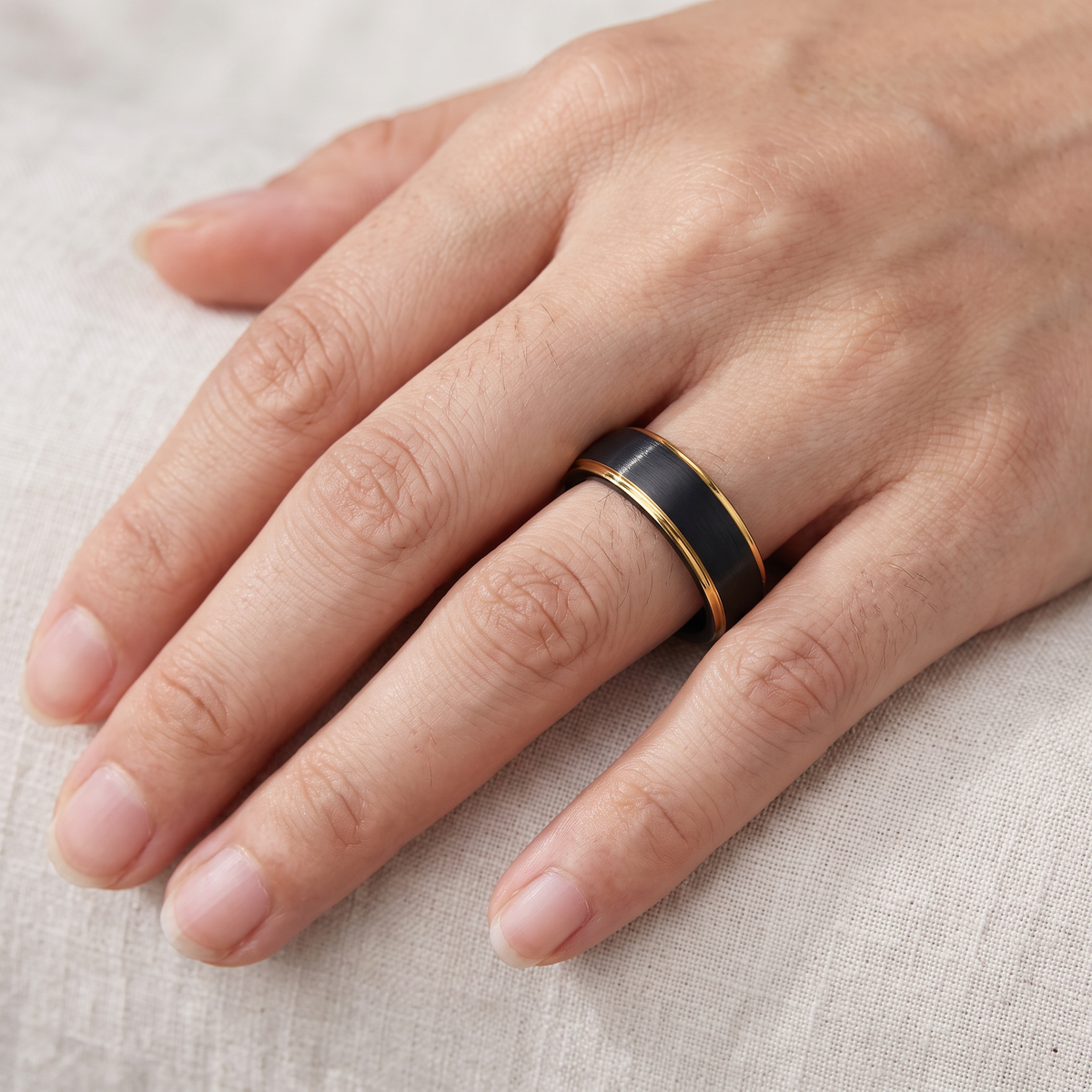 Close up of a woman's hand wearing The Corona black tungsten ring