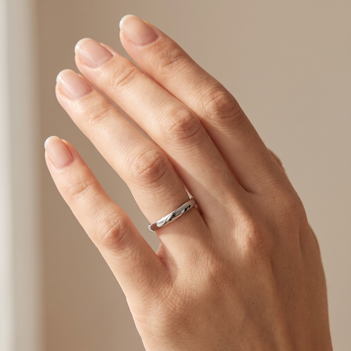 Close up of a woman's hand wearing The Filament silver tungsten ring