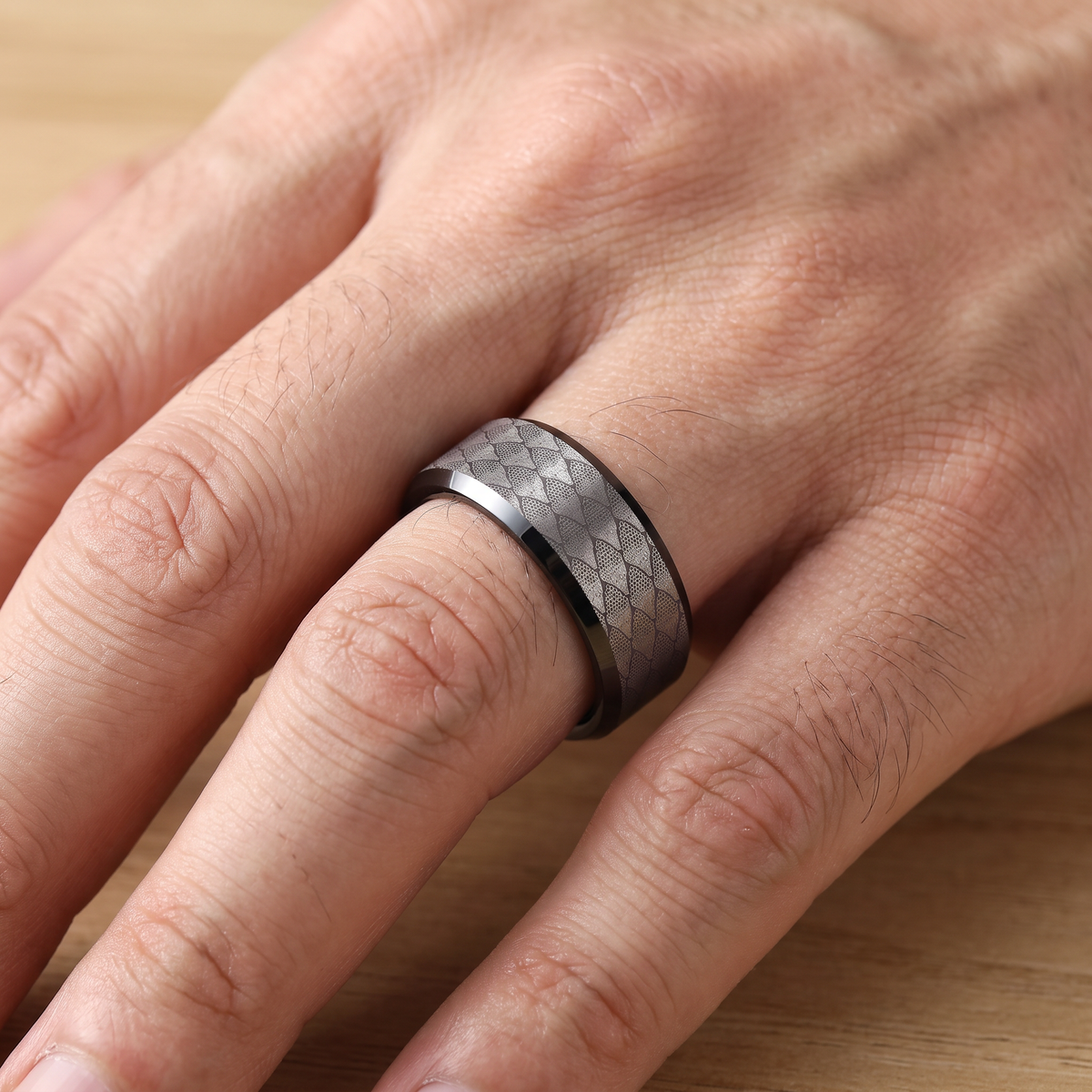 Close up of a man's hand wearing The Serpentine tungsten ring with a black interior