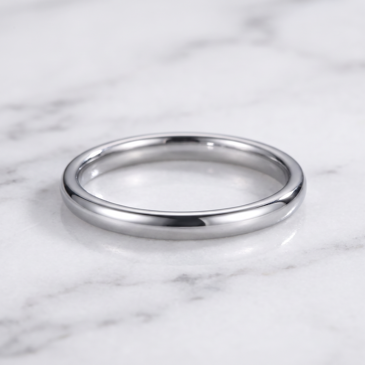 The Filament silver tungsten ring lying flat on white marble