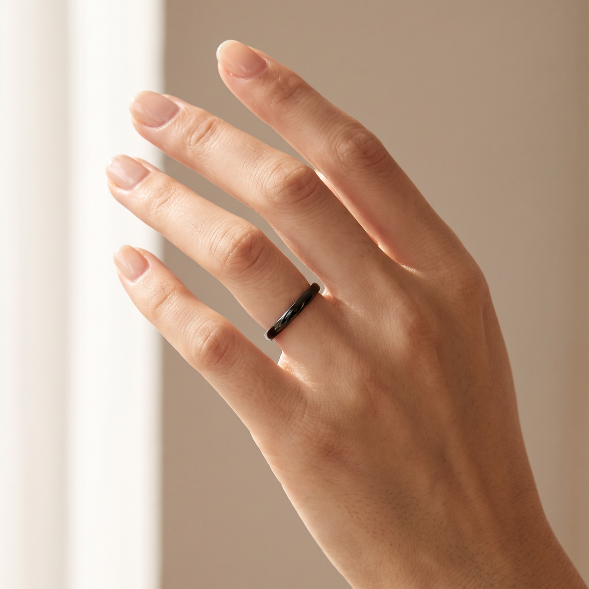 Close up of a woman's hand wearing The Filament black tungsten ring