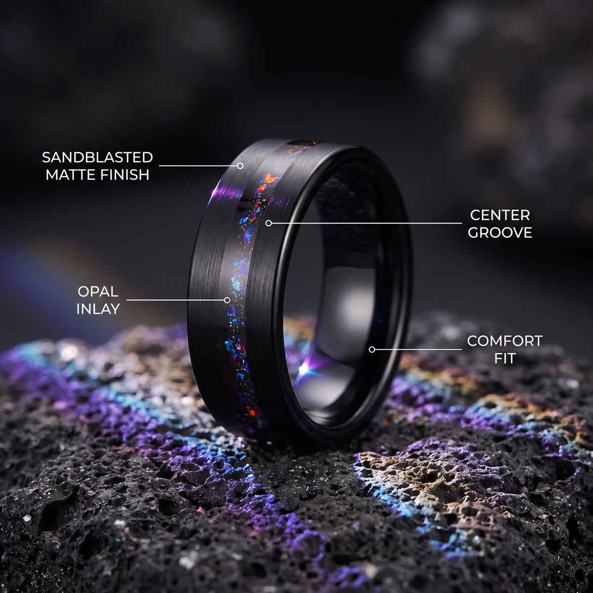 Black tungsten ring on dark volcanic stone with callouts for sandblasted matte finish, opal inlay, center groove and comfort fit