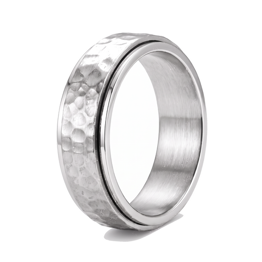 The Orbit silver stainless steel spinner ring with a hammered band on a white background