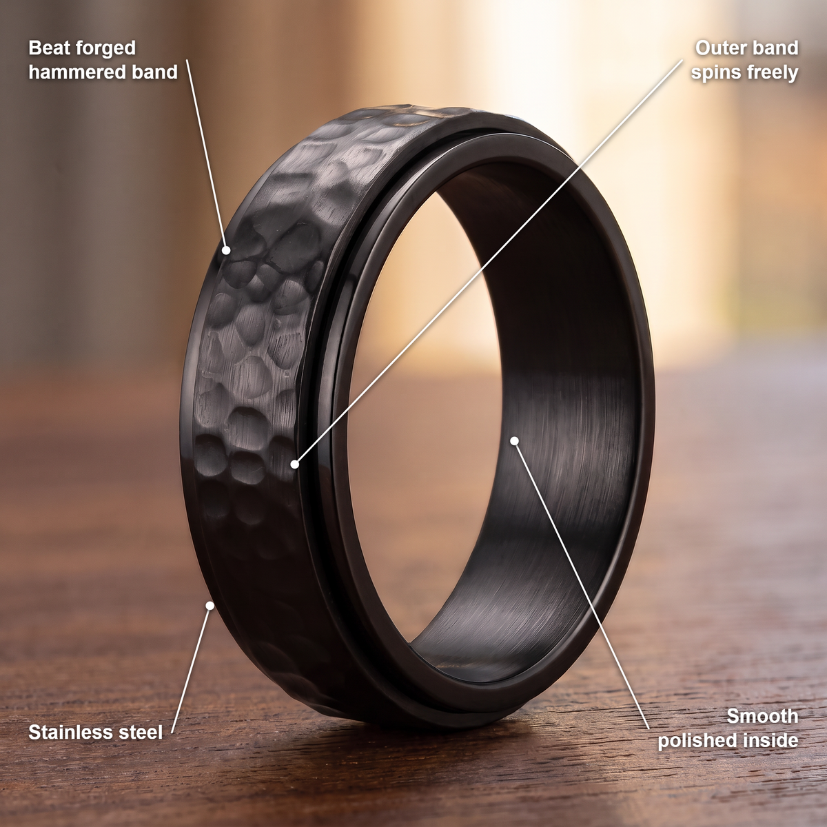 The Orbit ring details in black: beat forged hammered band, outer band spins freely, stainless steel, smooth polished inside