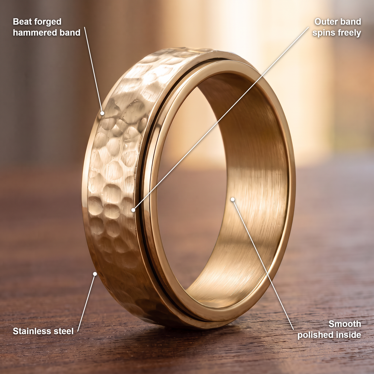 The Orbit ring details in gold: beat forged hammered band, outer band spins freely, stainless steel, smooth polished inside