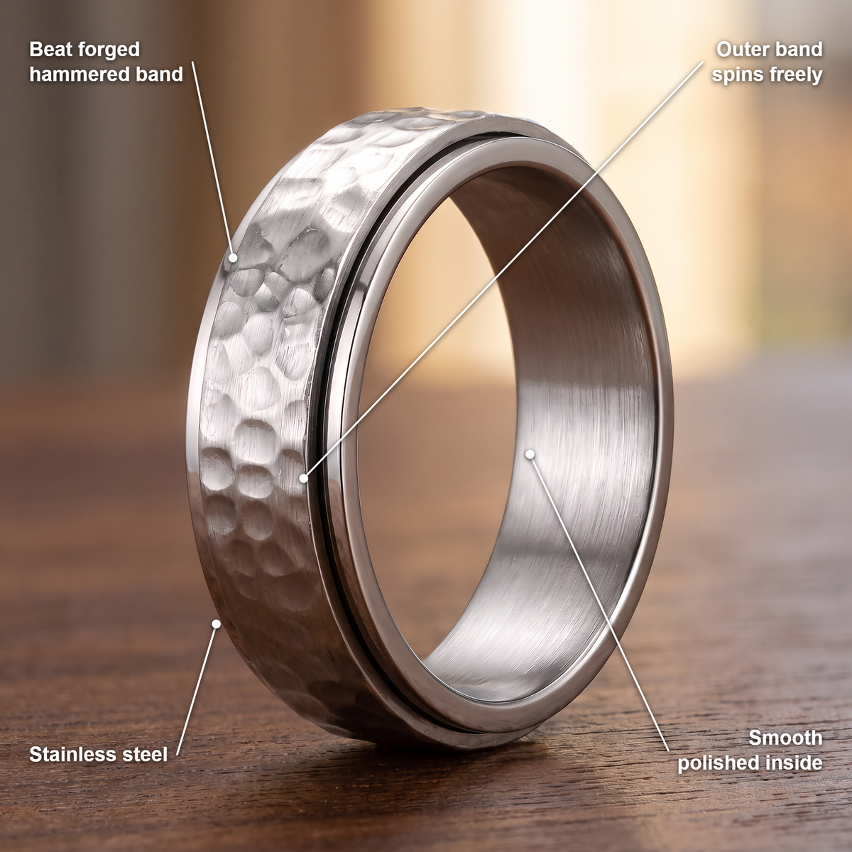 The Orbit ring details in silver: beat forged hammered band, outer band spins freely, stainless steel, smooth polished inside