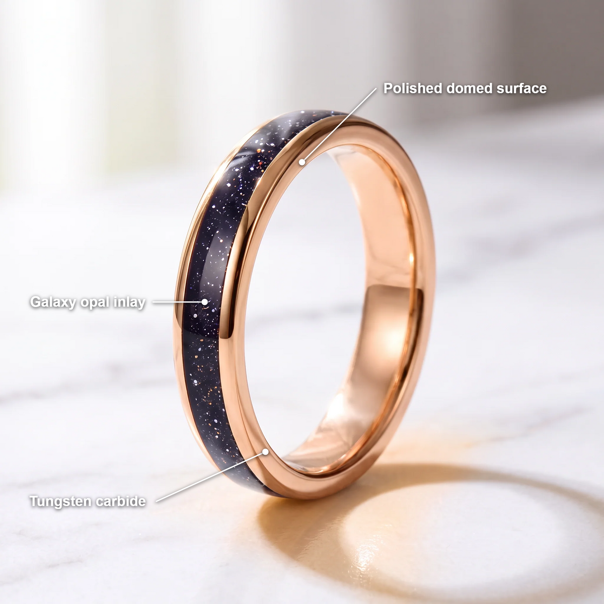 The Vega rose color tungsten ring with a galaxy opal inlay and feature callouts